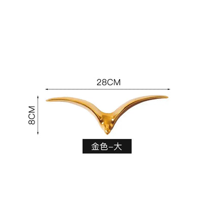 Modern gold and white ceramic bird pendant wall decor with sleek finish and outstretched wings for living room