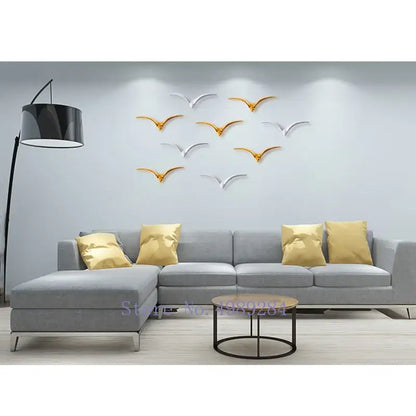 Modern gold and white ceramic pendant wall decor featuring silver and gold metallic bird wall decor decals for living room