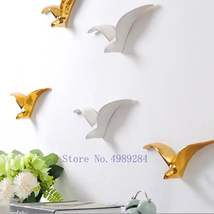 Modern gold and white ceramic pendant wall decor featuring bird design ideal for living room wall decor