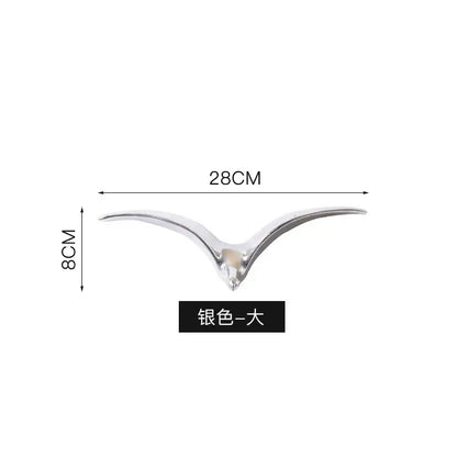 Silver-colored sleek bird-shaped car ornament with polished metallic finish for modern pendant wall decor use