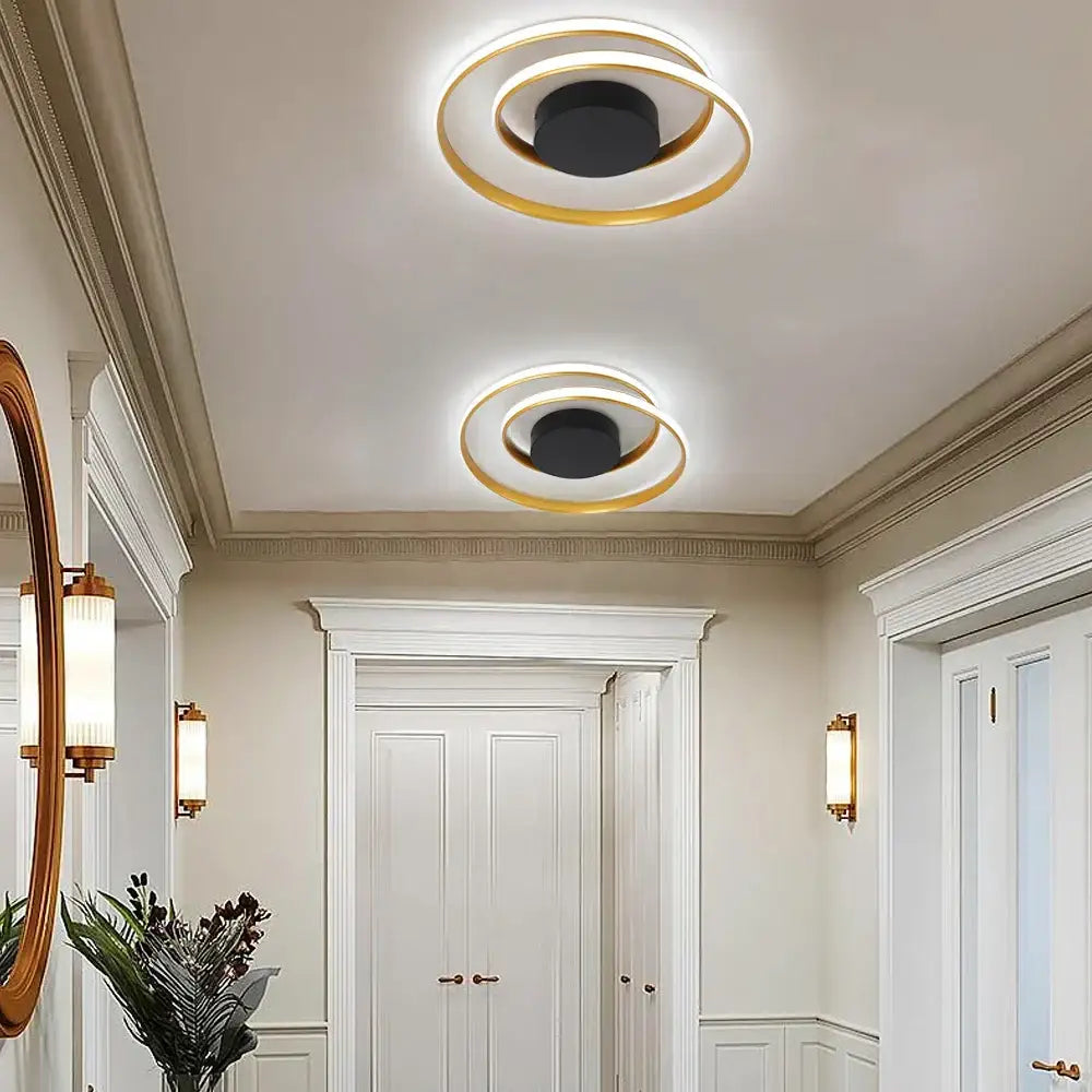 Modern gold and white dimmable led ceiling lamp with two concentric gold rings and black central disc decorbites dimmable led