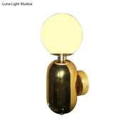 Modern gold wall sconce with white glass globe shade and sleek base compatible with e26 e27 bulbs for bedroom use