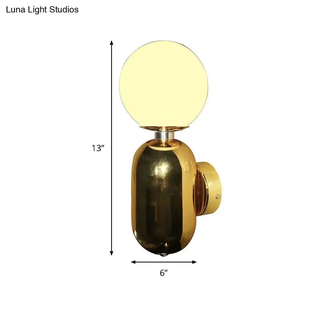 Modern gold wall sconce with white glass globe shade and polished brass base compatible with e26 e27 bulbs