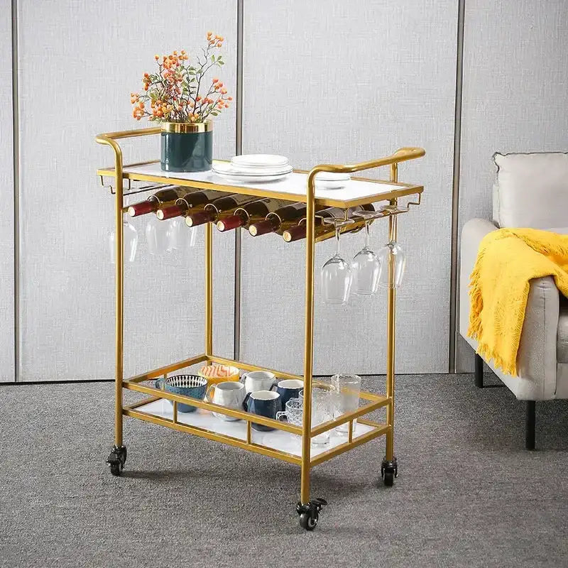 Modern gold and white marble bar cart featuring metal wine rack bottle holders and glassware drinks trolley shelves