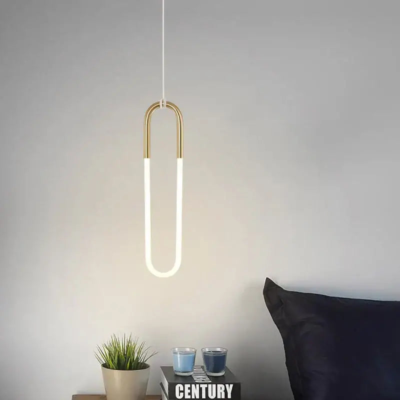 Modern gold pendant lights featuring a gold-toned u-shaped design with a glowing white led tube for living room decorbites pendant lights