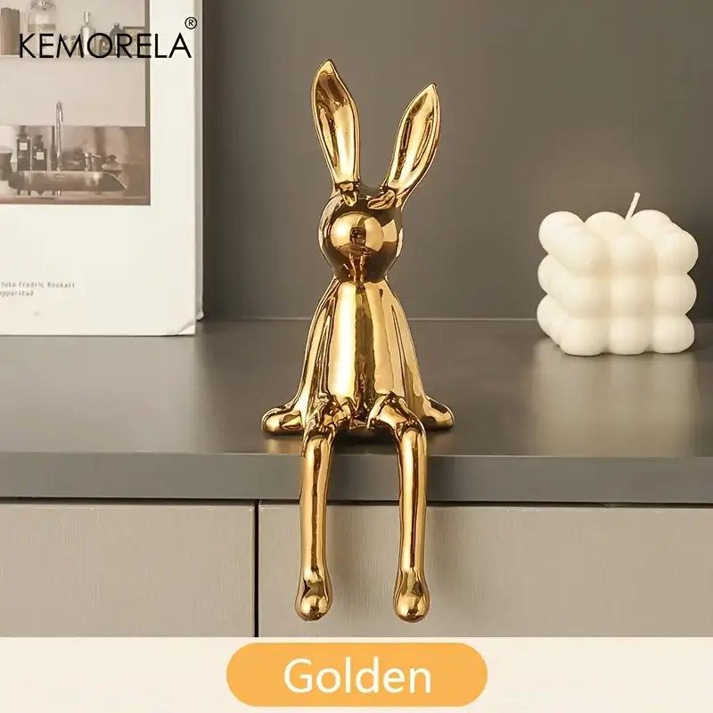 Modern gold ceramic sitting rabbit ornament with sleek glossy finish and minimalist design for living room decor