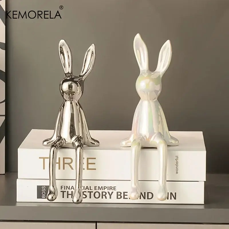 Two ceramic sitting rabbit ornaments with silver reflective and iridescent white glaze for living room decor