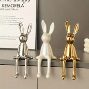Three glossy ceramic sitting rabbit ornaments in gold white and silver finishes for modern living room decor