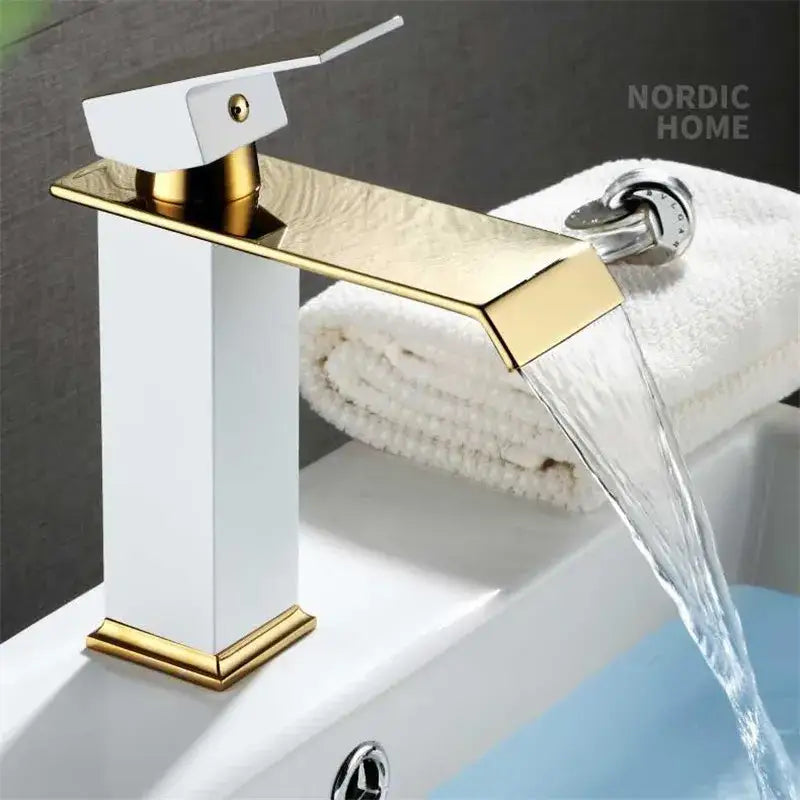 Modern gold white waterfall basin faucet with a white rectangular body and gold accents for bathroom sinks decorbites gold white