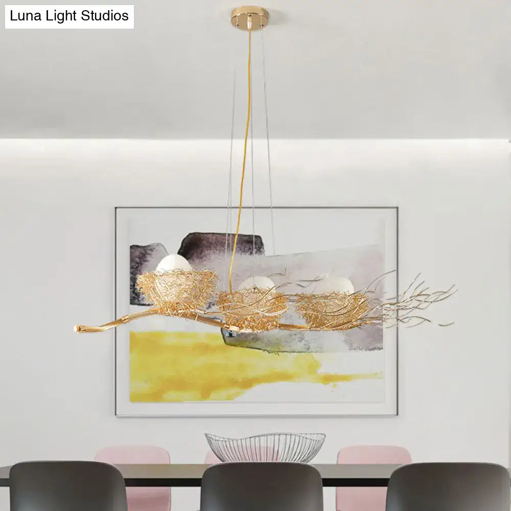 Gold-toned wire mesh bird nest chandelier with three egg-shaped bulbs for modern restaurant lighting