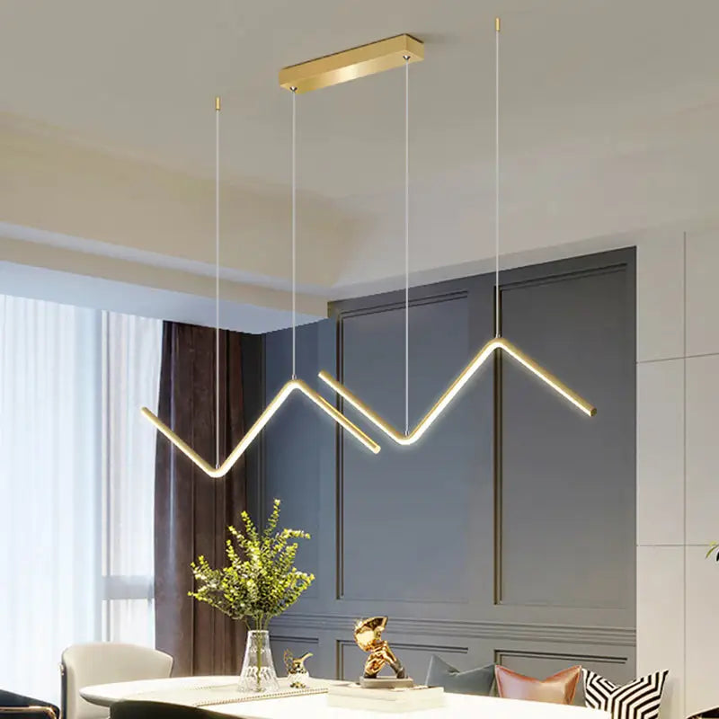 Modern gold-toned zigzag pendant lighting fixture with sleek design and minimalist rectangular ceiling mount for dining room