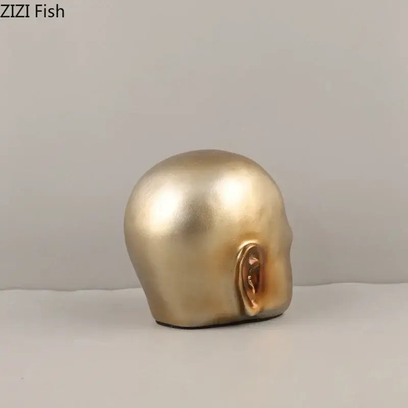 Modern golden abstract resin sculpture with a smooth metallic skull and detailed ear for office desk decorbites abstract resin ornament