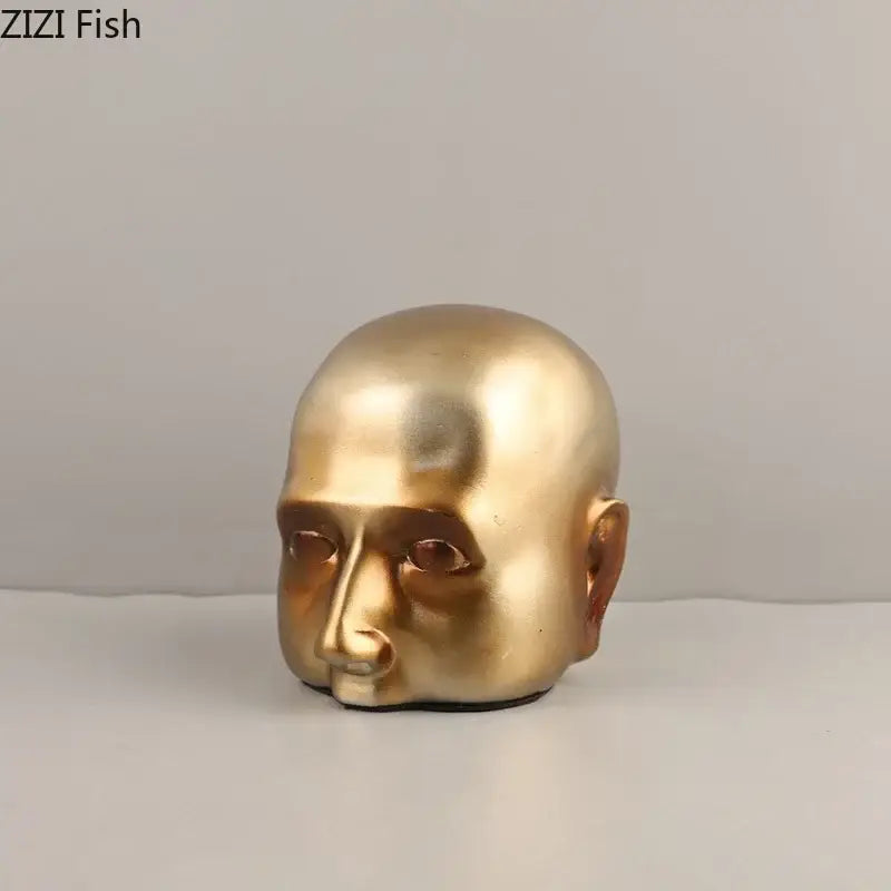 Golden metallic abstract resin sculpture ornament of a bald human head with smooth reflective surface for office decorbites decor