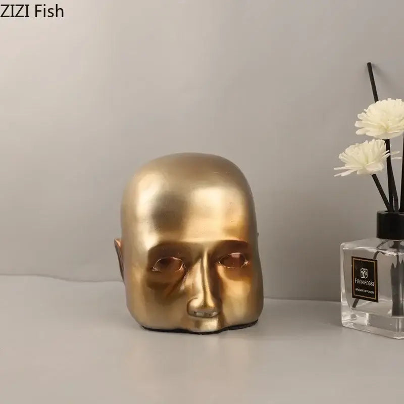 Modern golden abstract resin sculpture of a smooth reflective human head as decorbites abstract resin desk decor ornament