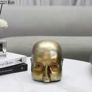 Modern golden abstract resin sculpture of a bald human head with smooth reflective surface for office desk decorbites abstract resin ornament