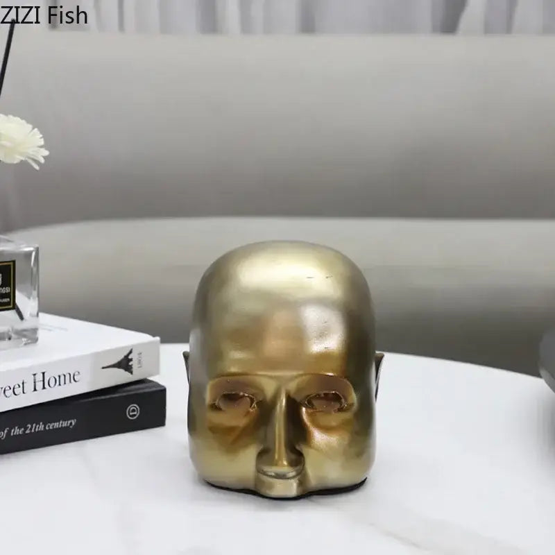 Modern golden abstract resin sculpture of a bald human head with smooth reflective surface for office desk decorbites abstract resin ornament