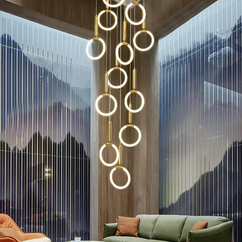 A modern decorbites golden acrylic round led chandelier with illuminated gold-toned rings for living room decor