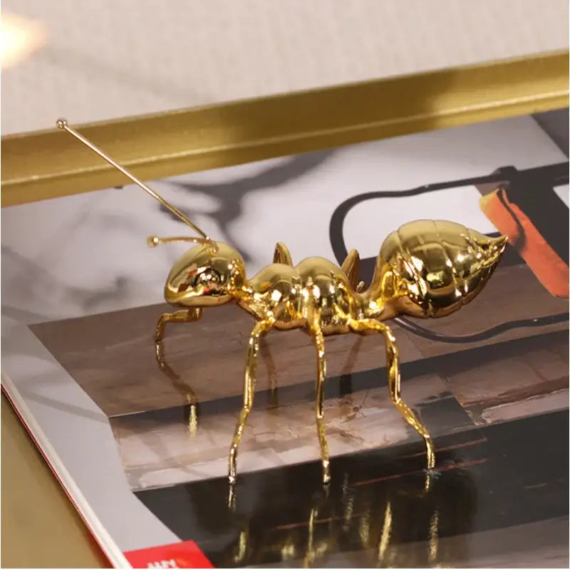 Shiny gold ant metal sculpture with detailed segmented body and long antennae for modern living room decorbites golden ant