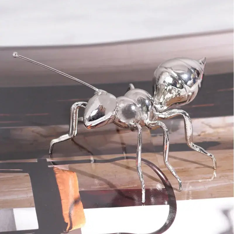 Shiny silver metallic ant figurine with reflective surface and detailed segmented body modern golden ant metal sculpture decorbites golden ant decor