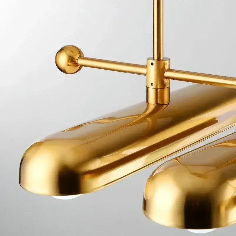 Modern golden art deco iron chandelier with gold-toned brass pendant light and sleek dome-shaped shades for dining room decorbites golden art
