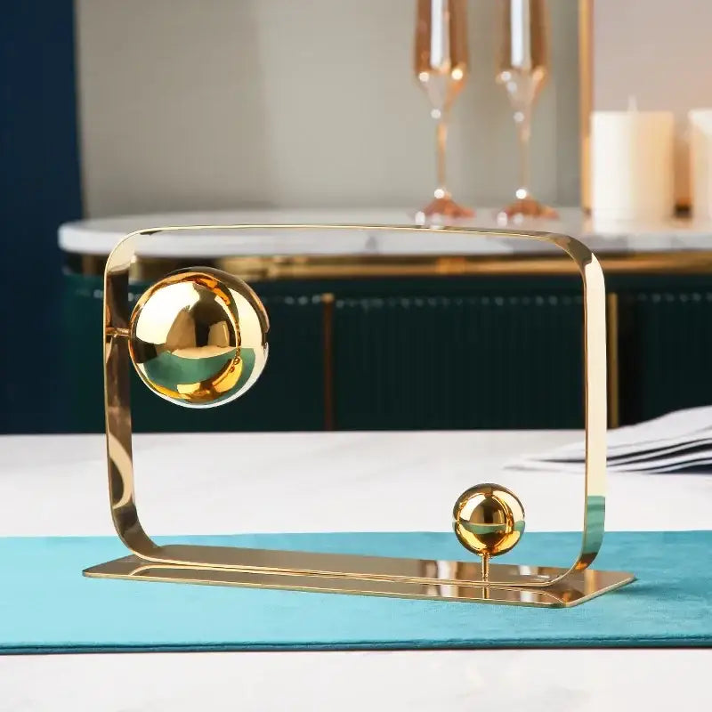 Modern golden ball cube sculpture with rectangular frame and two reflective golden balls for living room decorbites decor