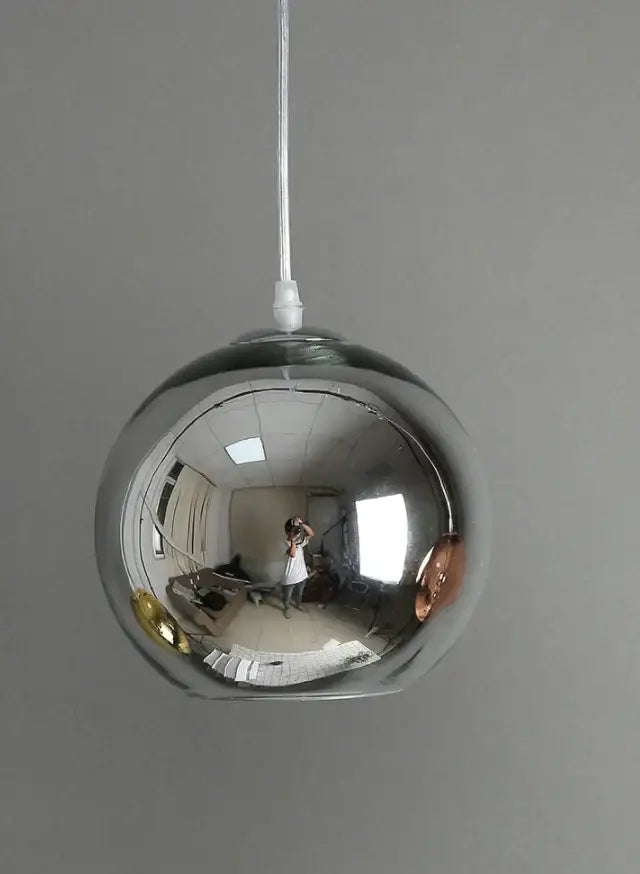 Modern golden ball glass pendant light with a sleek spherical chrome finish and reflective surface for pendant light decorbites