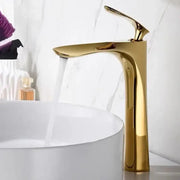Modern golden bathroom faucet with sleek curved single handle and polished metallic finish for decorbites golden bathroom decor