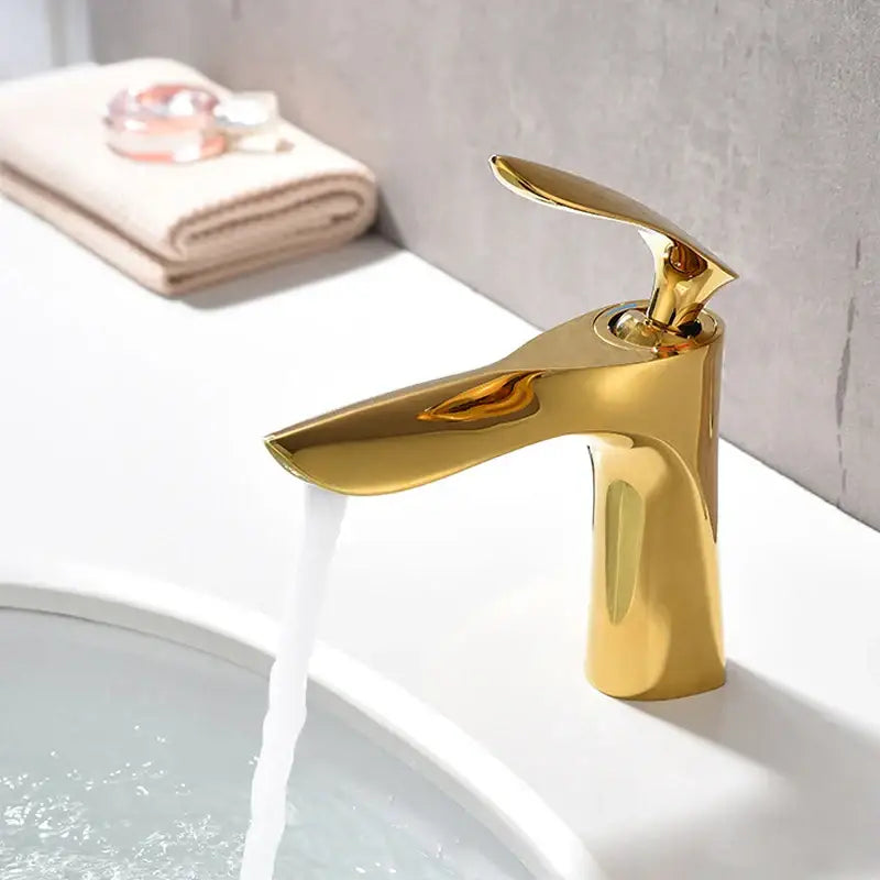 Modern golden bathroom faucet with sleek waterfall spout curved single handle from decorbites golden bathroom collection