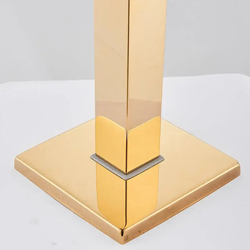 Modern golden bathtub shower faucet with gold-finished square base and reflective metallic column stand by decorbites