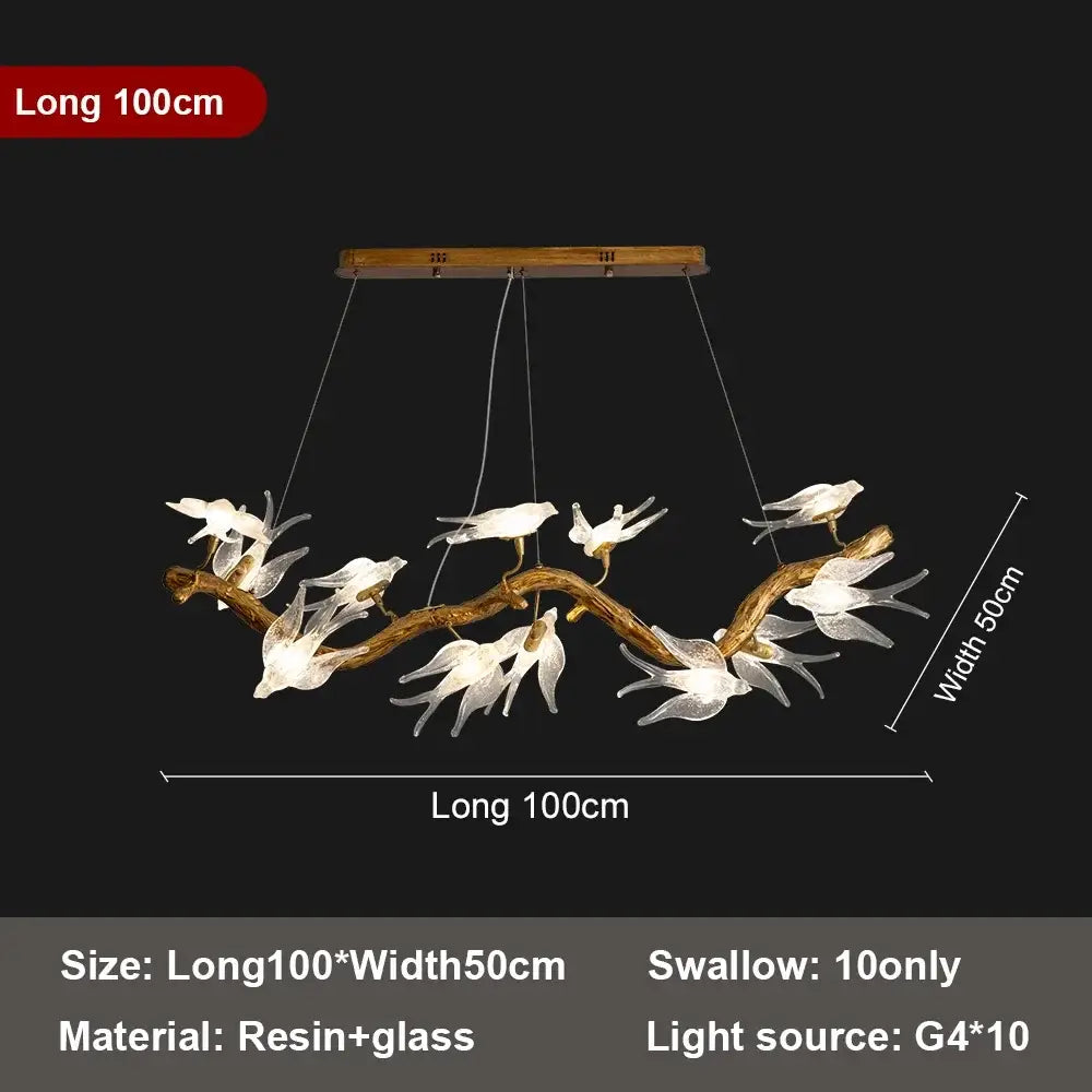 Modern golden bird crystal glass branch chandelier with ten translucent white glass swallows on a rustic resin branch