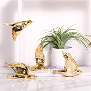 Modern golden bird wall hanging with reflective metallic finish and detailed feathers for living room decor