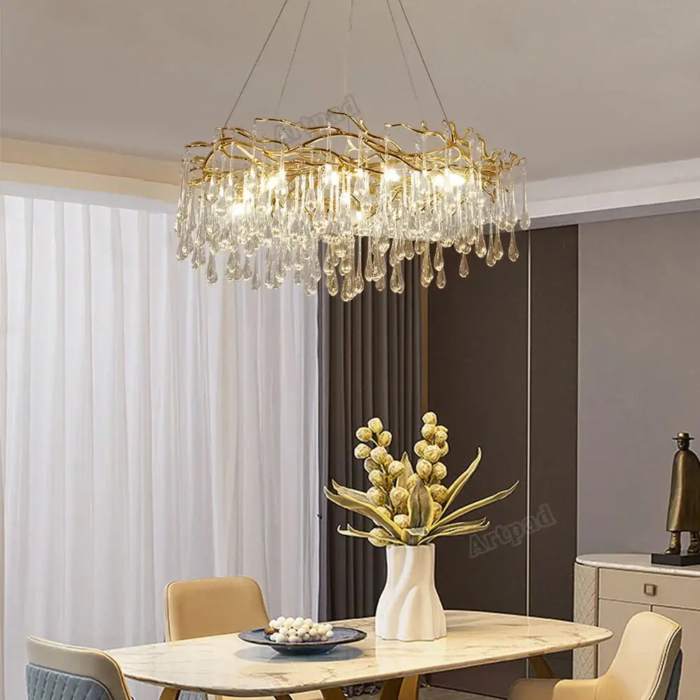 Modern golden branch led ceiling chandelier with gold-toned metal frame and cascading clear crystal droplets decorbites golden branch