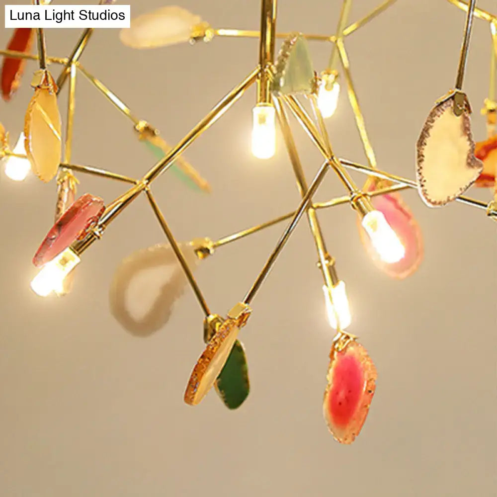 A modern DecorBites™ metal LED island light fixture with gold frame and multicolored agate accent and adjustable cord length