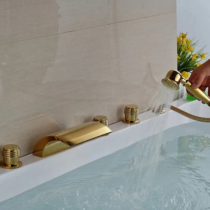 Modern golden brass bathtub faucet with sleek cylindrical handles and handheld shower by decorbites golden brass