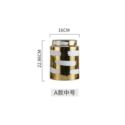 A modern decorbites golden ceramic jar with glossy gold finish and bold white stripes for living room storage