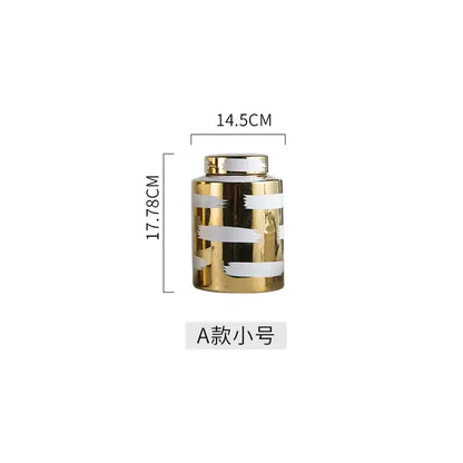 A sleek decorbites golden ceramic jar with white brushstroke stripes and a matching metallic lid for living room storage