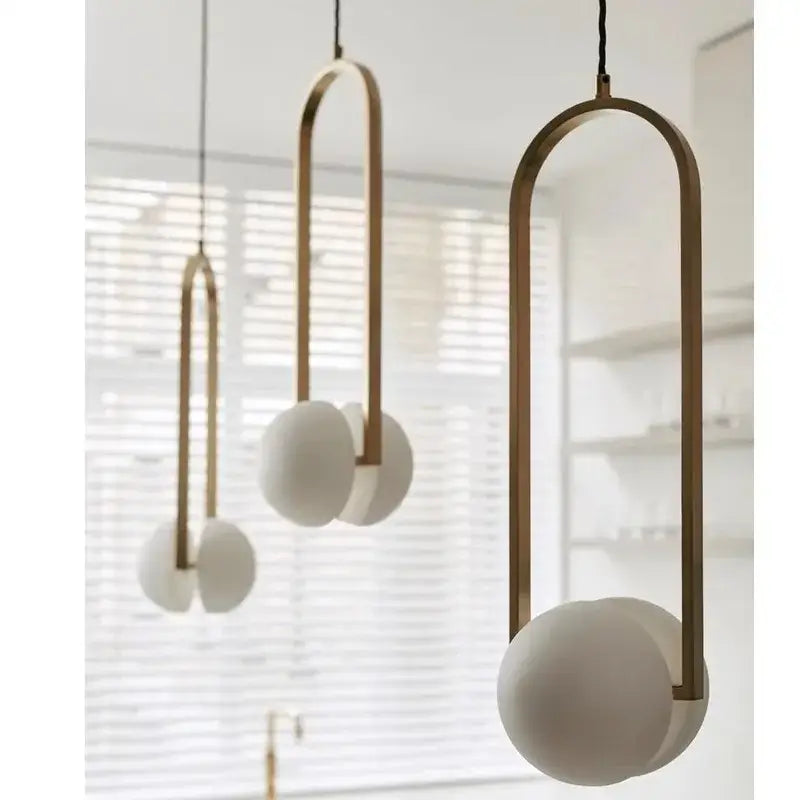 Modern brass arched pendant lights with frosted white glass spheres for dining room decorbites golden chandelier led