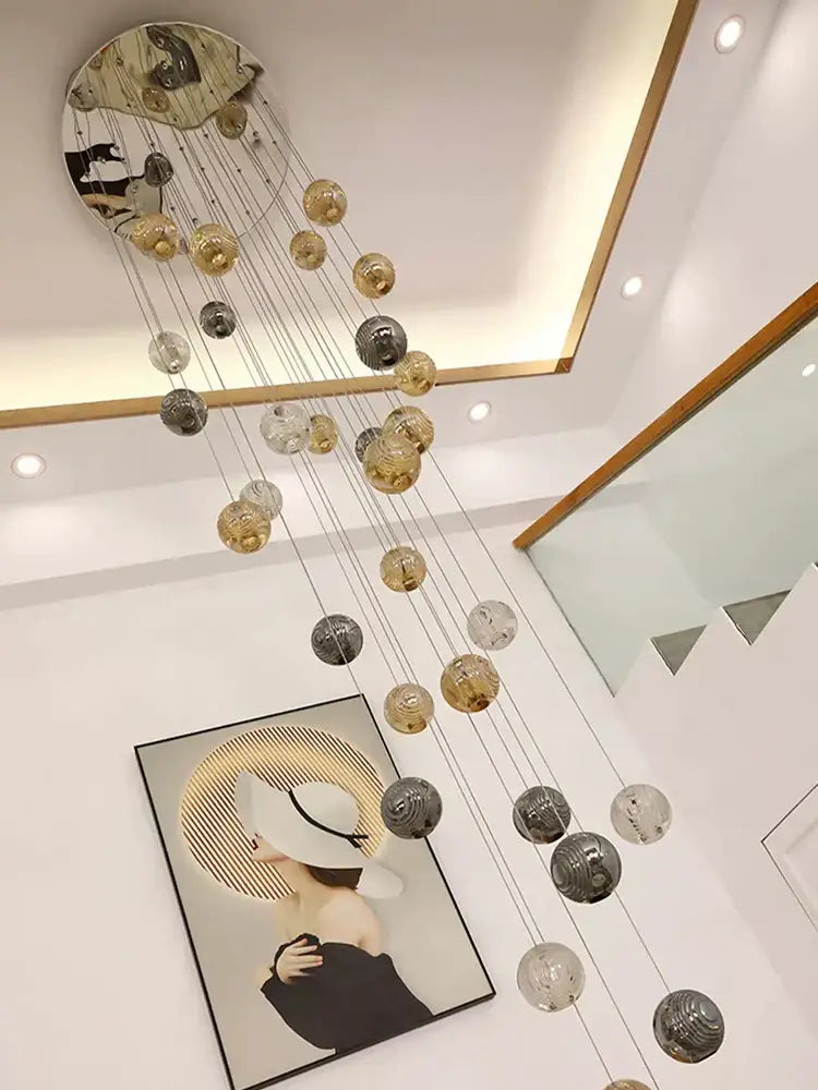 Modern golden crystal glass spiral ceiling chandelier with circular mirrored top and hanging decorbites crystal glass orbs