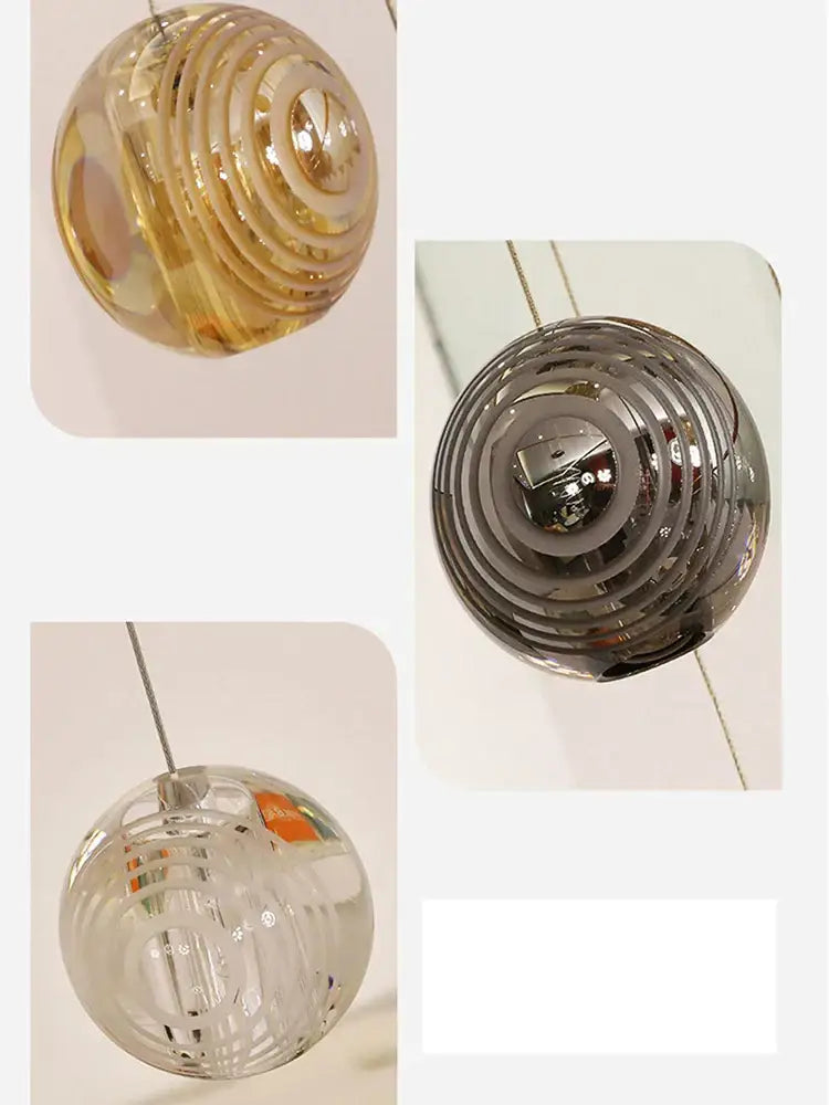 Modern golden crystal glass spiral ceiling chandelier with clear glass spherical pendant light featuring concentric ridges