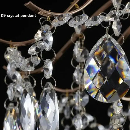 Modern golden crystal led chandelier featuring clear k9 crystal pendant with faceted teardrop and oval beads suspended by silver-toned rings