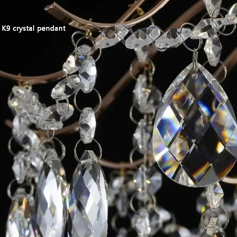 Modern golden crystal led chandelier featuring clear k9 crystal pendant with faceted teardrop and oval beads suspended by silver-toned rings