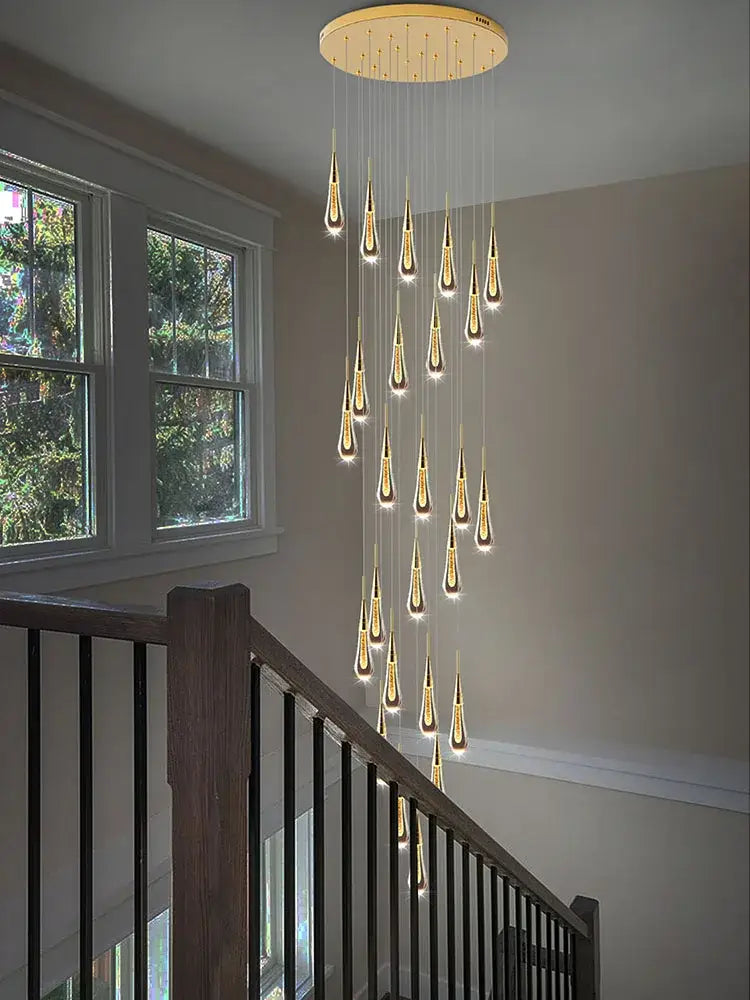 A modern golden crystal pendant chandelier with teardrop led lights by decorbites for elegant living room decor