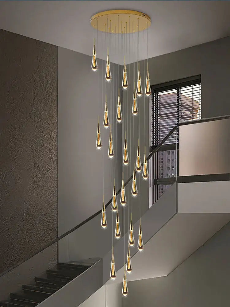 Modern golden crystal pendant chandelier with teardrop decorbites crystal pendant lights in an elegant living room decor