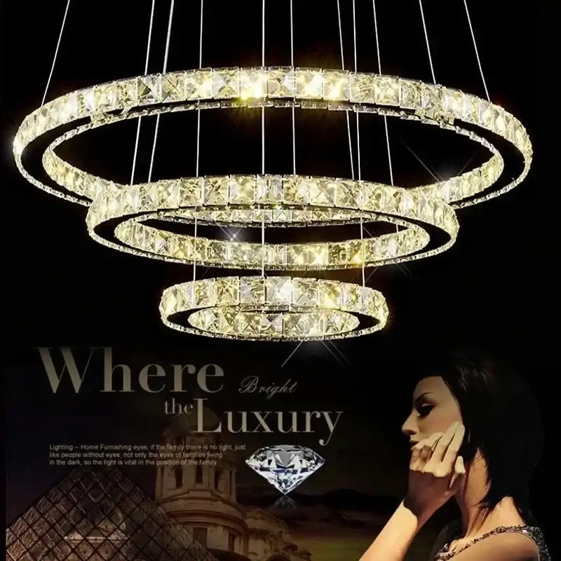 Modern golden crystal ring ceiling chandelier with three concentric crystal rings emitting warm golden glow for dining room light