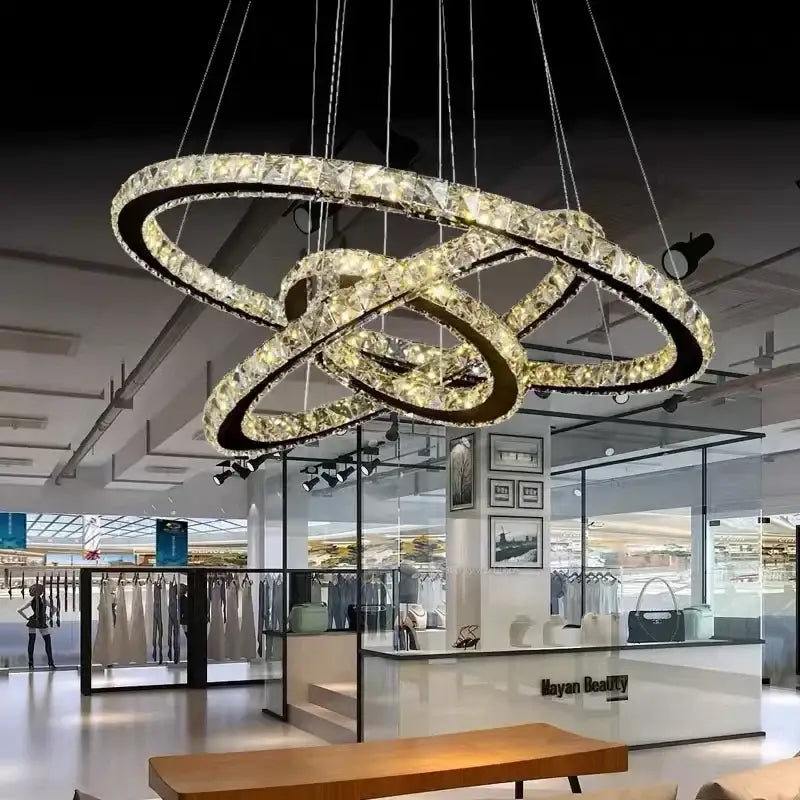 Modern black frame crystal ring ceiling chandelier with interlocking rings and warm light for dining room decorbites crystal ring