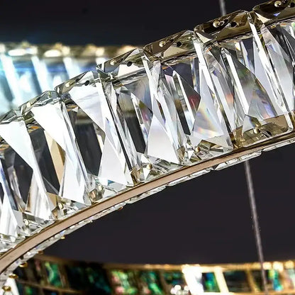 A modern golden decorbites crystal ring ceiling chandelier with faceted crystal prisms in a polished metal frame