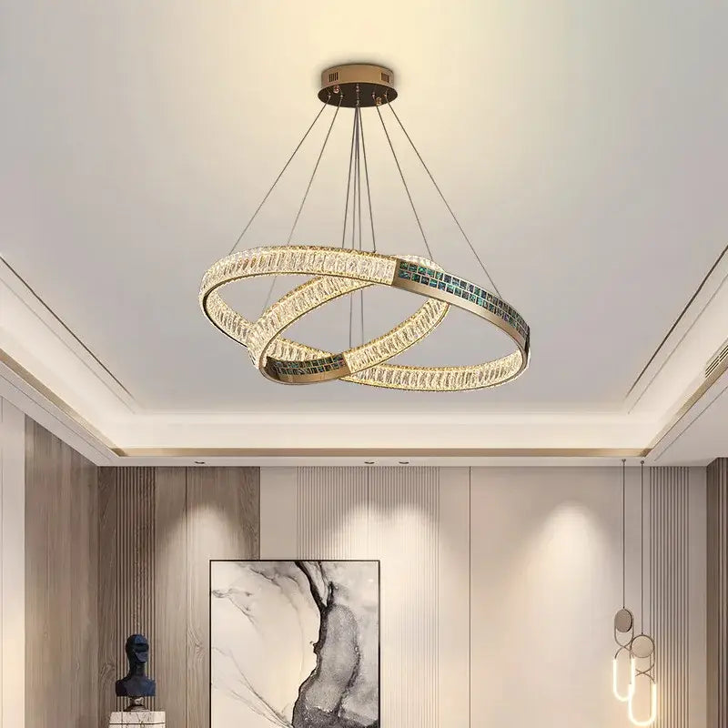 Modern golden crystal ring ceiling chandelier with gold-toned metal, clear crystals, and teal-green glass tiles by decorbites