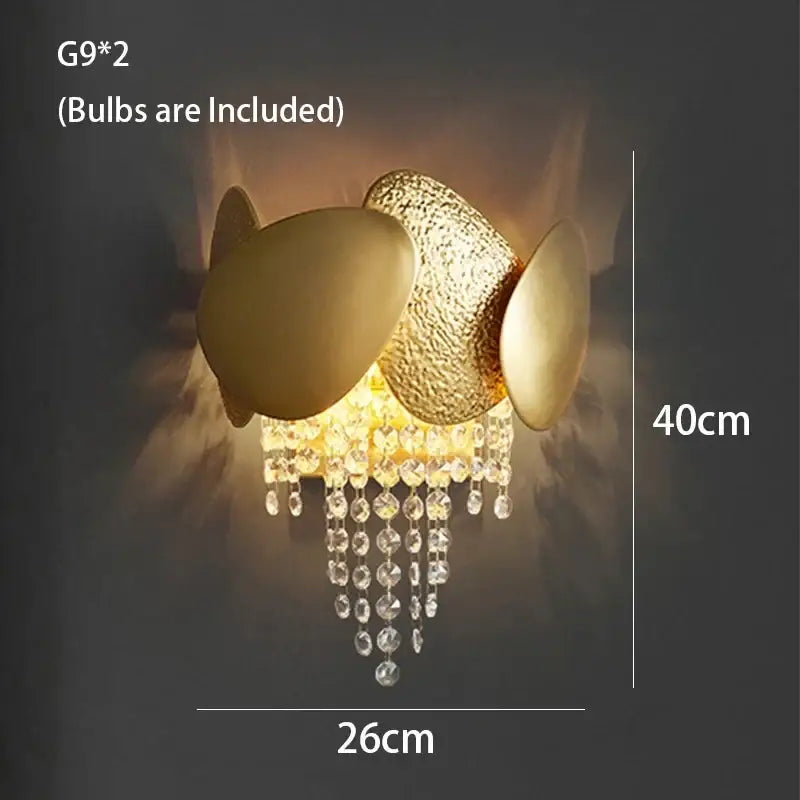 Gold-toned decorbites crystal chandelier wall sconce with textured and smooth orbs and dangling crystal beads for living room