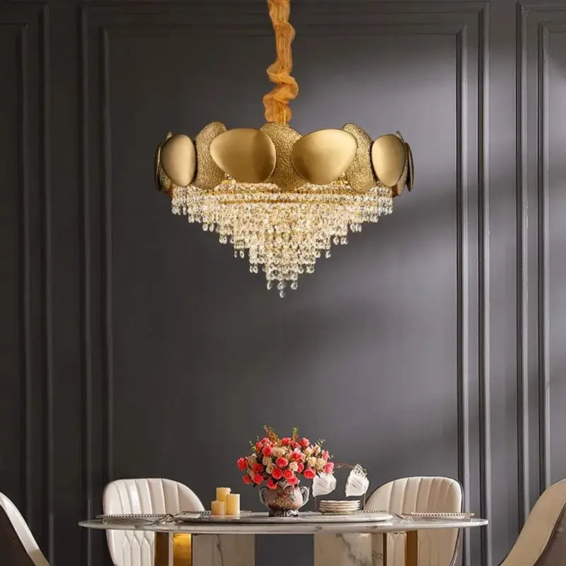 Modern golden decorbites crystal chandelier with textured shell design and cascading crystal droplets for living room