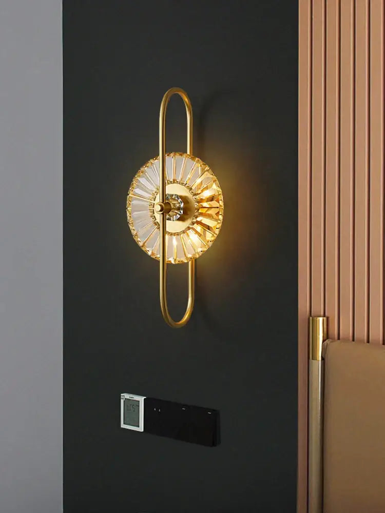 Modern golden decorbites crystal wall light with gold-toned sunburst crystals and curved arm for bedroom lighting